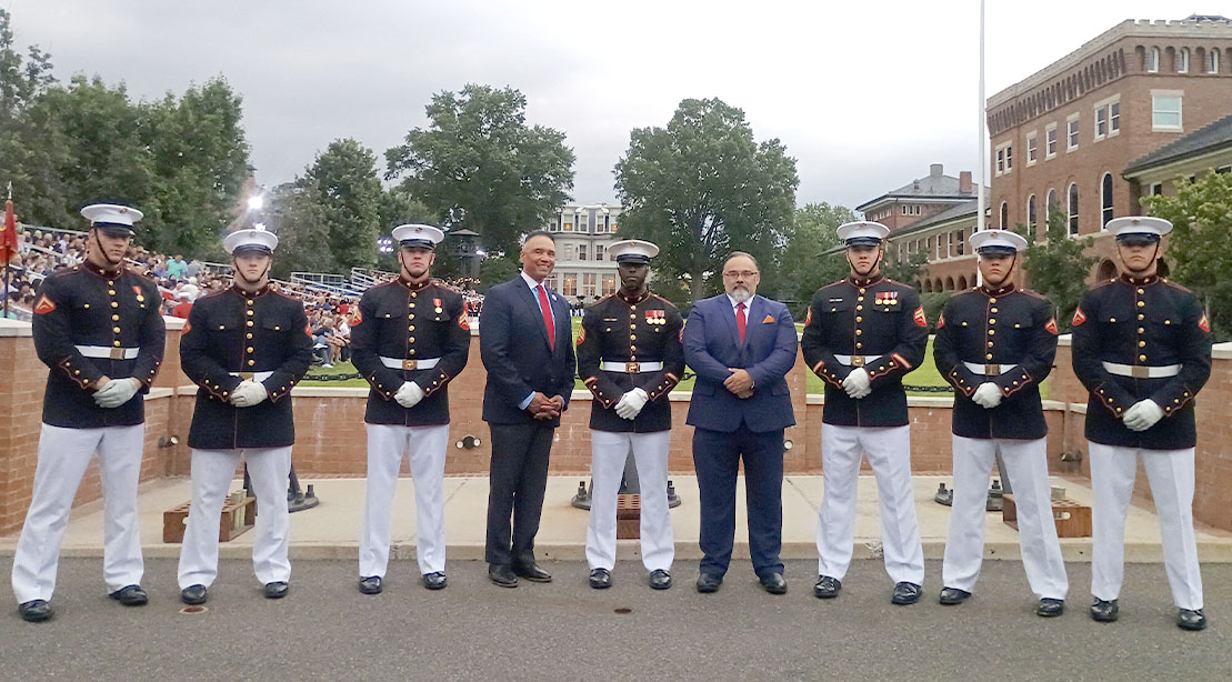 Roger Lockridge and Rob Wilking standing with military guards for Fit To Serve